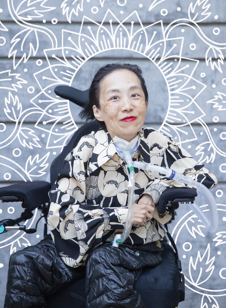 A color photograph of Alice Wong by Eddie Hernandez with white illustrative lines framing her done by Michael Luoong. Alice Wong sits in her wheelchair, smiling at the camera. She is an Asian woman wearing bright red lipstick and a smart blouse featuring white graphic flowers on a black background. Her feeding tube runs into her throat. 